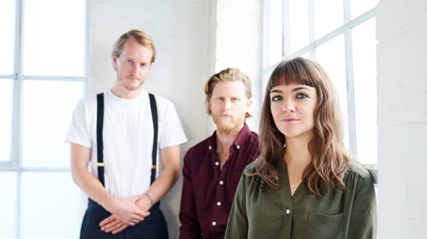 The Lumineers Wallpapers show three band members posing near large windows with natural light, HD Desktop Wallpaper