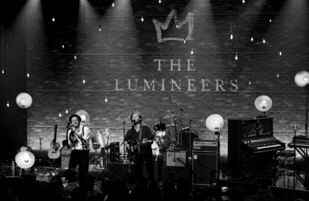 The Lumineers perform on stage in a black and white concert setting, 2K Desktop Wallpaper
