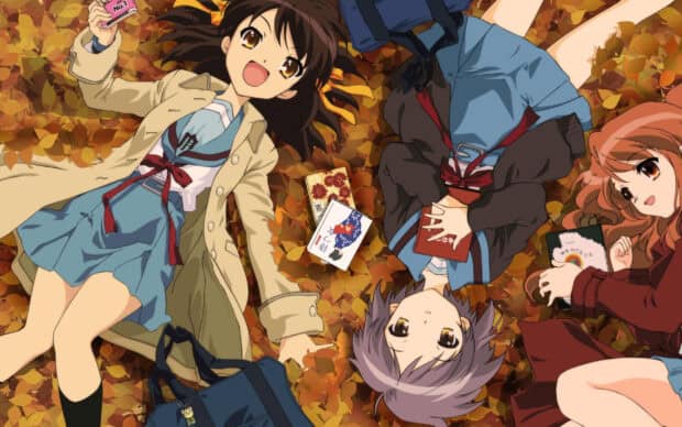 Three characters from The Melancholy Of Haruhi Suzumiya lie on autumn leaves with books, 2K Desktop Wallpaper