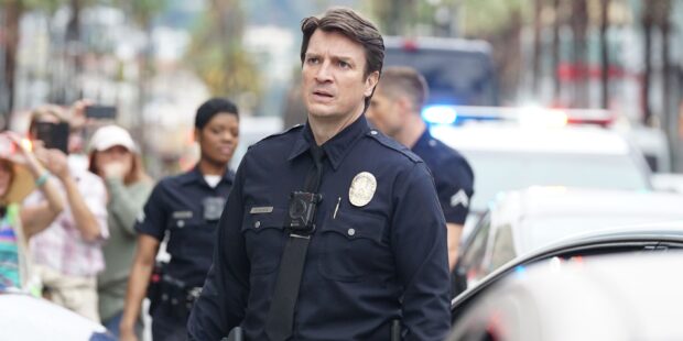 A police officer in uniform from The Rookie Tv Series looks concerned on a busy street, 2K Desktop Wallpaper