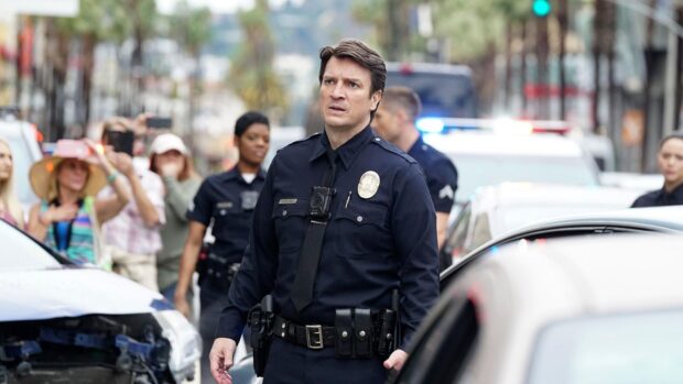 A police officer from The Rookie Tv Series is investigating an incident on a busy street, HD Desktop Wallpaper