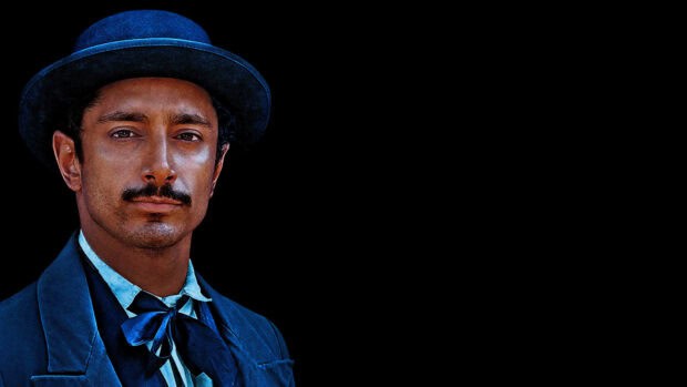 A close up of a man wearing a blue suit and hat from The Sisters Brothers, 4K Desktop Wallpaper