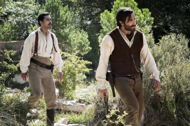 Two men in western attire walking through a forest in The Sisters Brothers, HD Desktop Wallpaper