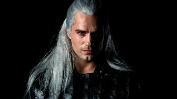 A close up of The Witcher with silver hair and yellow eyes in dark armor, HD Desktop Wallpaper