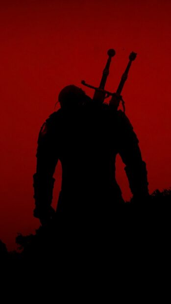 A dark figure with two swords stands against a vivid red sky in The Witcher Tv Series Wallpapers, HD Phone Wallpaper