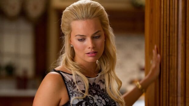 A close up of a woman from The Wolf Of Wall Street looking thoughtful indoors, 2K Desktop Wallpaper