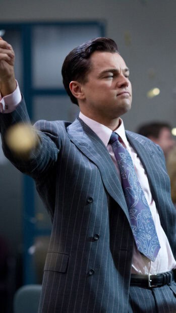 The Wolf Of Wall Street shows confidence in a pinstripe suit with a determined expression, HD Mobile Wallpaper