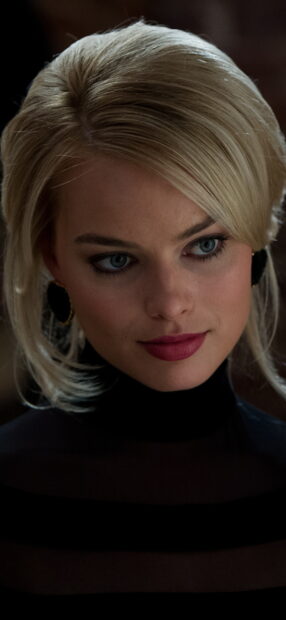 A close up image of a woman character from The Wolf Of Wall Street with detailed facial features, HD Mobile Wallpaper