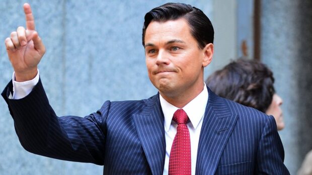 The Wolf Of Wall Street character raises his hand with a gesture in a scene, HD Desktop Wallpaper