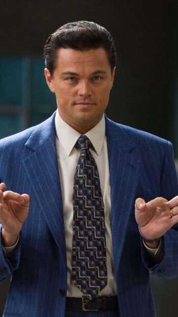 A man in a blue pinstripe suit and patterned tie makes a confident gesture in a business setting, HD Phone Wallpaper