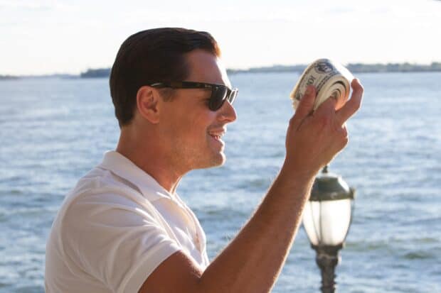 A man wearing sunglasses holding a roll of cash by the water, 2K Desktop Wallpaper