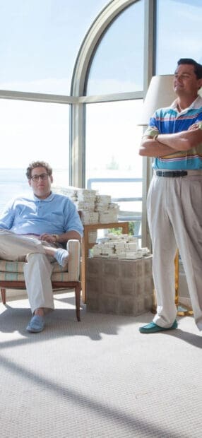 Two men from The Wolf Of Wall Street with bundles of money near a large window, HD Phone Wallpaper