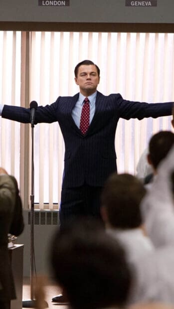 A man in a suit stands confidently with arms outstretched before a crowd, The Wolf Of Wall Street Wallpapers, HD Mobile Wallpaper