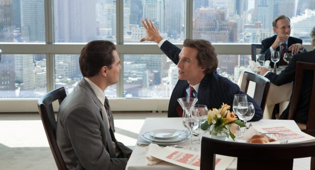 Two men in suits discuss business during a restaurant meeting with a city view, 2K Desktop Wallpaper