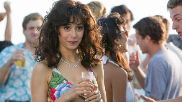 A woman holding a drink at a lively gathering from The Wolf Of Wall Street, HD Desktop Wallpaper