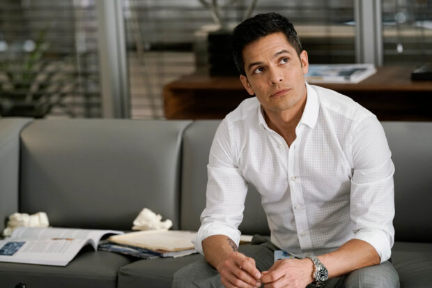 A man named Nicholas Gonzalez is sitting and looking up thoughtfully in an office setting, 2K Desktop Wallpaper
