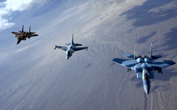 Three jet fighters fly in formation over a vast desert landscape, HD Desktop Wallpaper