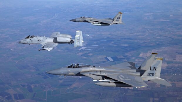 Three military jet fighters are flying in formation above the rural landscape, 4K Desktop Wallpaper