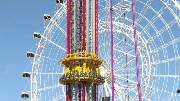 A thrilling amusement ride and ferris wheel are seen in Orlando with clear blue skies, HD Desktop Wallpaper