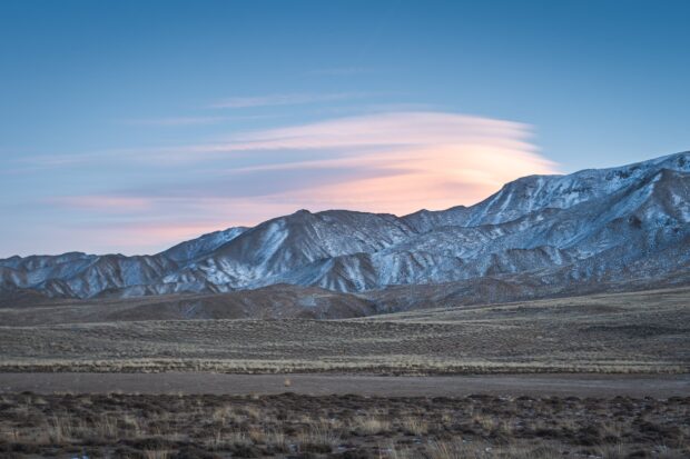 The Tibetan Highlands display snow dusted peaks under a soft pastel sky at dusk, HD Desktop Wallpaper