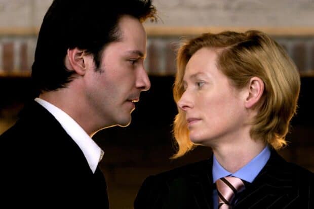 Tilda Swinton and Keanu Reeves face each other closely in a dramatic scene, 2K Desktop Wallpaper