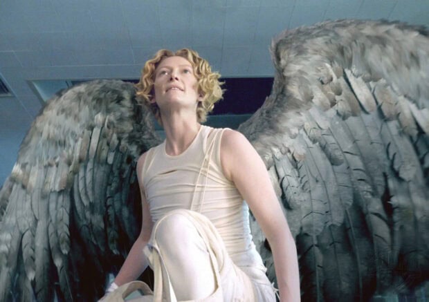 Tilda Swinton is kneeling wearing white clothes with large feathered wings behind her, HD Desktop Wallpaper