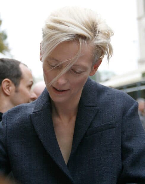 Tilda Swinton wallpapers featuring a close up of the actress with tousled blonde hair, HD Mobile Wallpaper