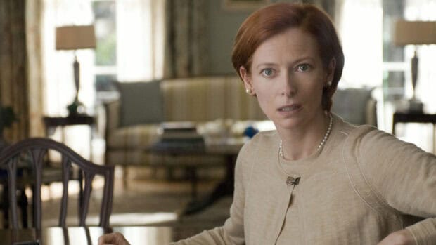 Tilda Swinton has an intense expression while sitting in a cozy room, HD Desktop Wallpaper