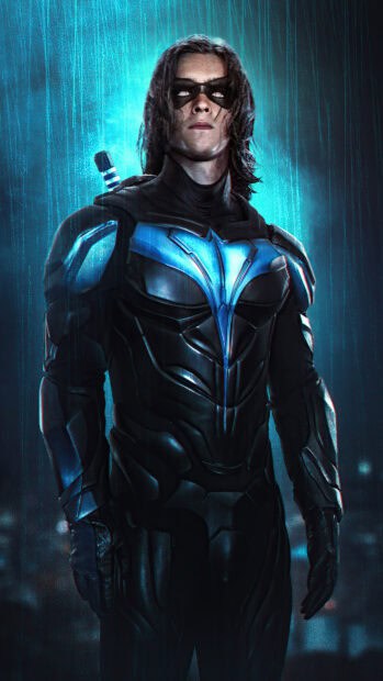 A dark hero in a detailed suit stands in the rain with glowing blue highlights from Titans Tv Series, 4K Phone Wallpaper