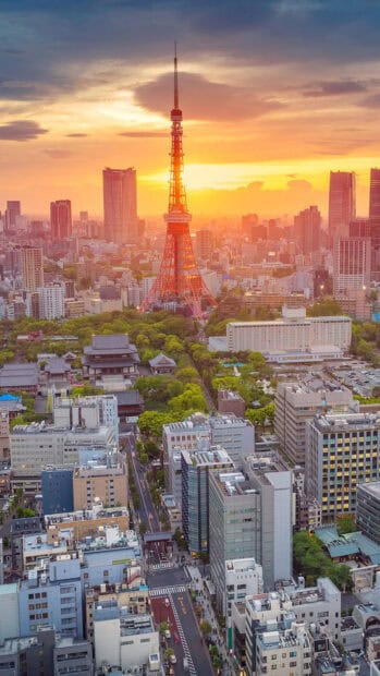 The Tokyo Tower stands tall during sunset in the bustling city of Tokyo, 4K Mobile Wallpaper