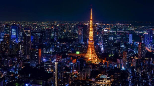 The Tokyo Tower glows brightly in the nighttime Tokyo cityscape full of lights, HD Desktop Wallpaper