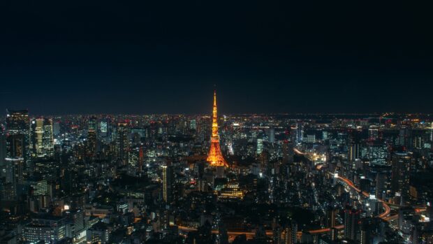 Tokyo Tower stands bright amidst the Tokyo cityscape at night with glowing lights, 4K Desktop Wallpaper