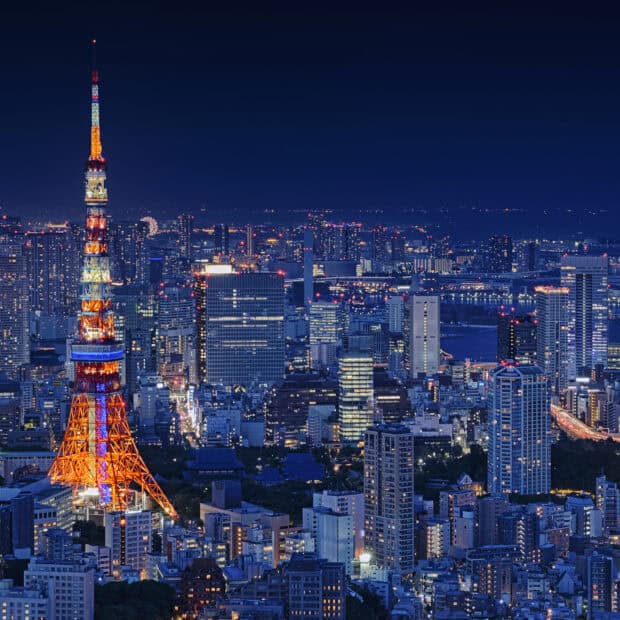 The Tokyo Tower is brightly lit among city buildings at night, HD Phone Wallpaper