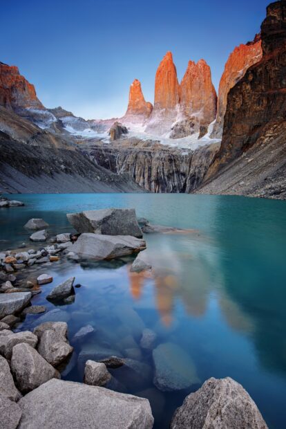 The famous Torres Del Paine National Park peaks reflect in the clear lake water at sunrise, 2K Mobile Wallpaper