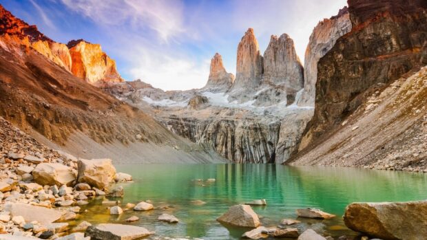 The turquoise lake is surrounded by rocky mountains at Torres Del Paine National Park, HD Desktop Wallpaper