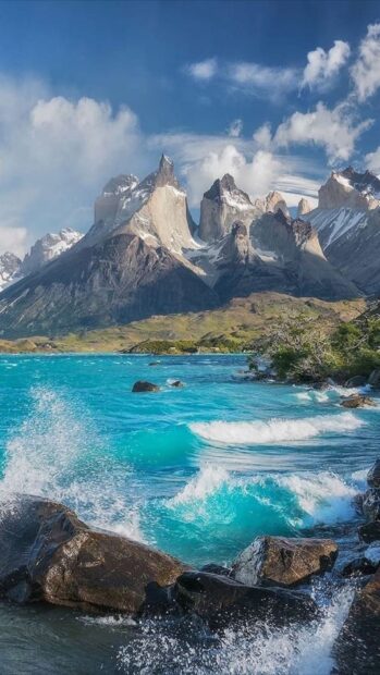 The bright blue water crashes against rocks near mountain peaks at Torres Del Paine National Park, HD Phone Wallpaper