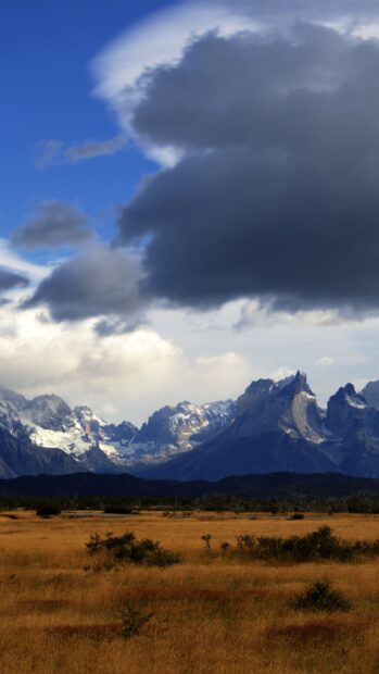 Dramatic clouds above the Torres Del Paine National Park mountain range, 4K Phone Wallpaper