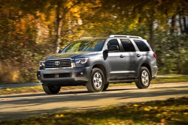 A gray Toyota Sequoia drives on a road with autumn colored trees in the background, HD Desktop Wallpaper