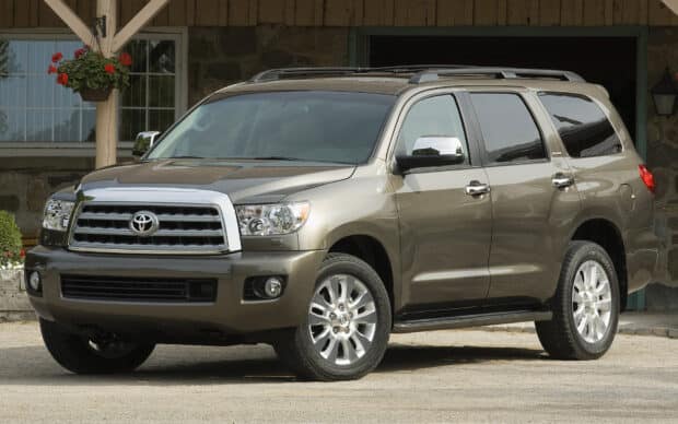A Toyota Sequoia SUV parked in front of a house with flowers nearby, HD Desktop Wallpaper