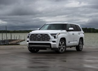 A white Toyota Sequoia is parked near a lake under cloudy skies, HD Desktop Wallpaper