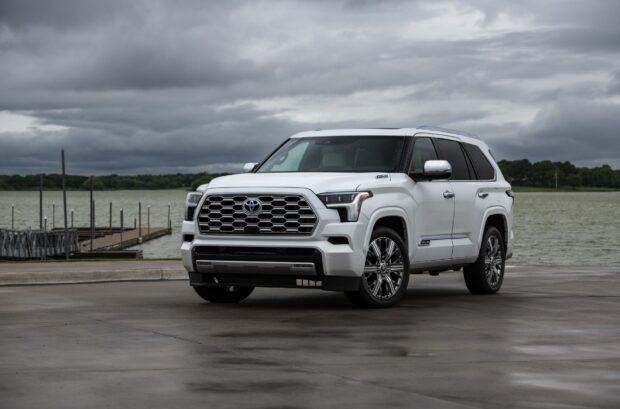 A white Toyota Sequoia is parked near a lake under cloudy skies, HD Desktop Wallpaper