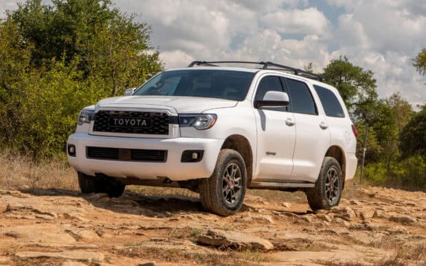 A white Toyota Sequoia driving on a rocky terrain under a cloudy sky, 2K Desktop Wallpaper