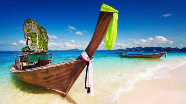 The traditional Thai boat floats near a sandy beach with clear water in Phuket, HD Desktop Wallpaper