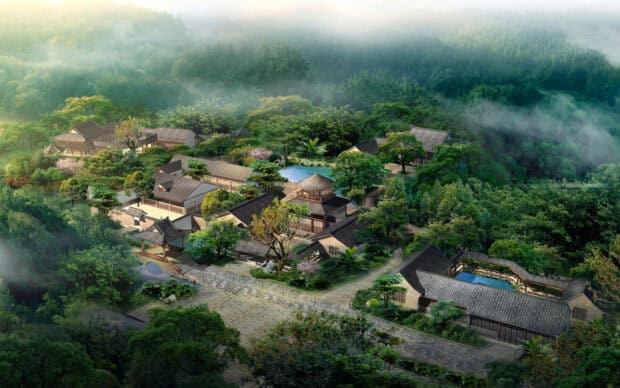 A traditional village surrounded by lush green forest and mist, HD Desktop Wallpaper