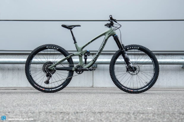 A Transition Bikes mountain bike stands against a concrete wall showcasing its features, HD Desktop Wallpaper