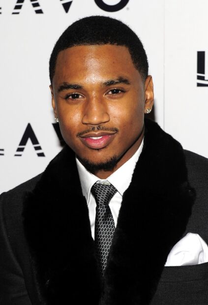 Trey Songz smiles wearing a black suit with a fur collar and patterned tie, 2K Mobile Wallpaper