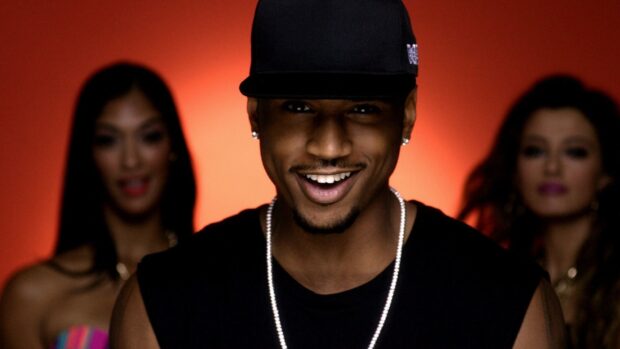 Trey Songz Wallpapers features a confident male artist smiling with two women behind him, HD Desktop Wallpaper