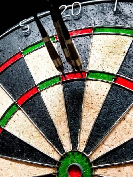 Three darts hitting the red bullseye area on the dartboard close up with clear colors, HD Mobile Wallpaper