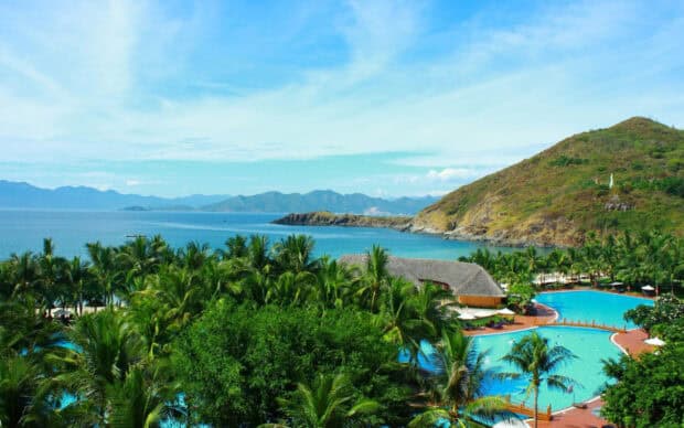 A tropical beach resort with Phuket wallpapers HD and 4K surrounded by palm trees and clear ocean water, 2K Desktop Wallpaper