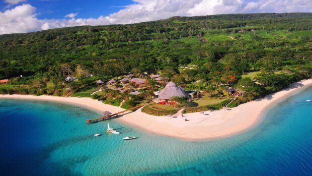 A serene tropical coastline with clear blue waters and lush greenery in Espiritu Santo Vanuatu, HD Desktop Wallpaper
